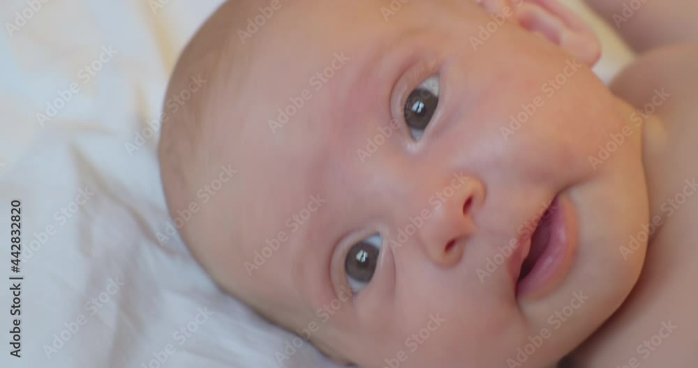 portrait of a modern child. Cute infant lying in bed.closeup portrait. portrait of a modern child. Cute infant lying in bed.closeup portrait.