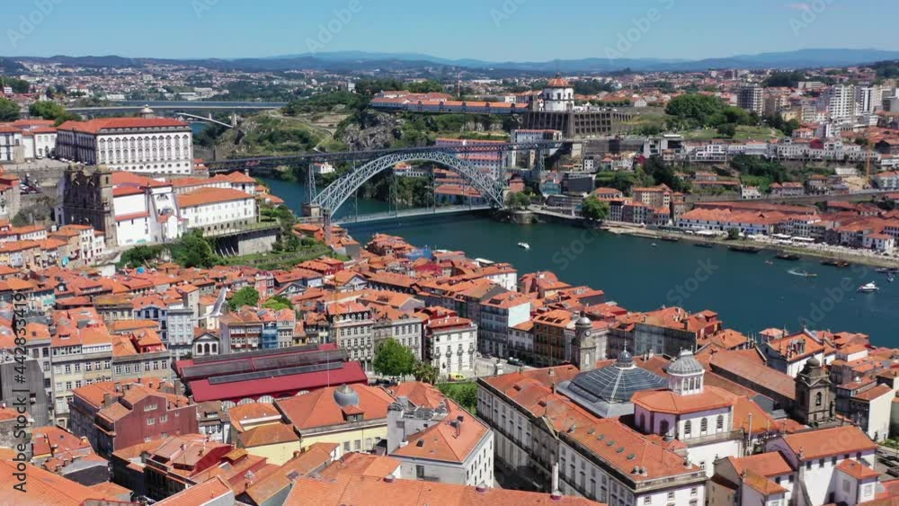 Cityscape and Old town of Porto Oporto City with historic architectures beside Douro River and Bridge in backdrop. Sunny day and beautiful weather in Portugal. Wild birds flying in the air. Cityscape and Old town of Porto Oporto City with historic architectures beside Douro River and Bridge in backdrop. Sunny day and beautiful weather in Portugal. Wild birds flying in the air.