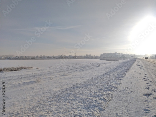 View of the village of Irtysh on the shores of the snow-covered lake Grkoye