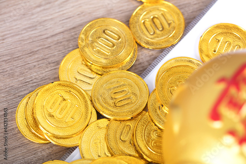 Golden calf piggy bank and gold coins