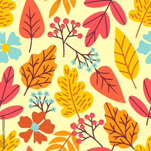 Bright vector seamless pattern for seasonal design. Red, yellow autumn leaves, blue, brown flowers, rowan berries on a light background. For print of fabric, textile products, stationery. School time.