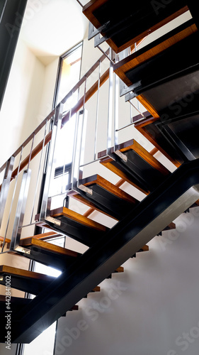 Steel staircase decorated with teak wood. Concept for design, interior and construction.