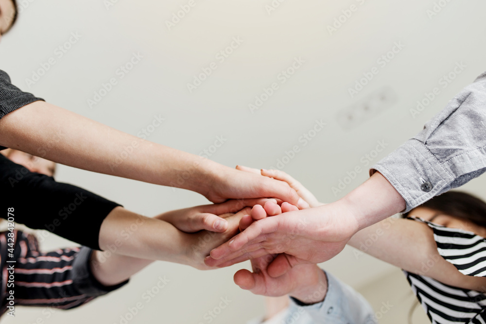 © Lena Ivanova - Group of people doing handshake and cross hands © Lena Ivanova - Group of people doing handshake and cross hands