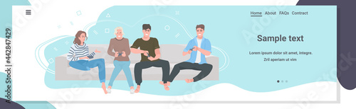 people sitting on sofa using joysticks friends having fun playing video games together