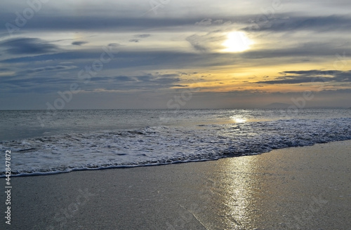 Fototapeta Naklejka Na Ścianę i Meble -  Beautiful sunset with clouds on the sea, in silver and orange colors