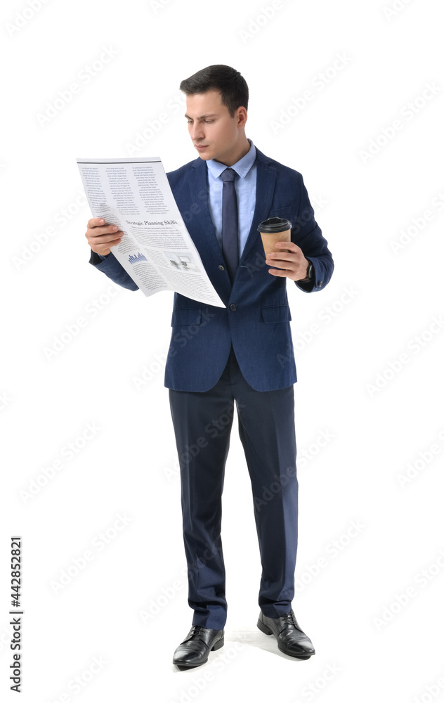 Young businessman with cup of coffee reading newspaper on white background Young businessman with cup of coffee reading newspaper on white background