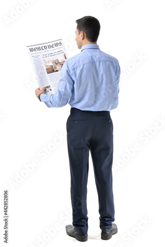 Young man reading newspaper...