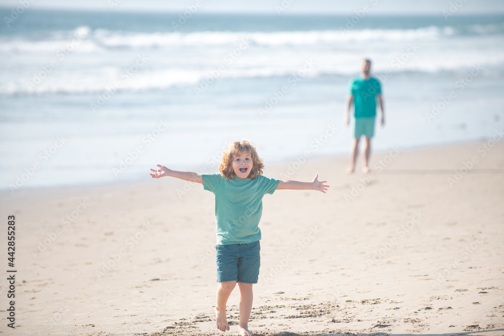 Kid boy walking to beach, raised hands. Amazed surprised kids emotions. Kid boy walking to beach, raised hands. Amazed surprised kids emotions.