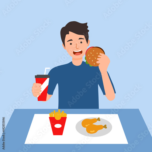 Young man eating fast food- hamburger, French fried, fried chicken and soda drink in flat design. Hungry guy eating lunch.