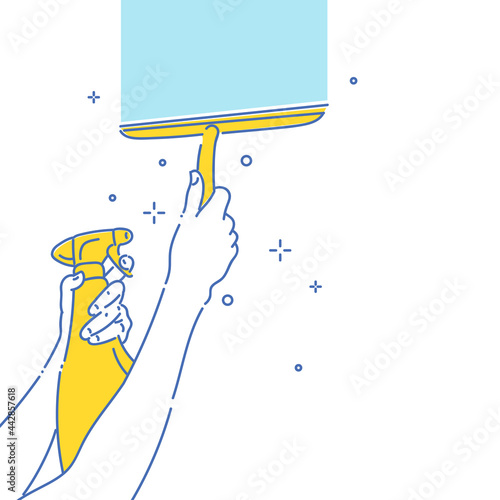 Image on the theme of cleaning and cleanliness. A persons hand is holding a window cleaner scraper.