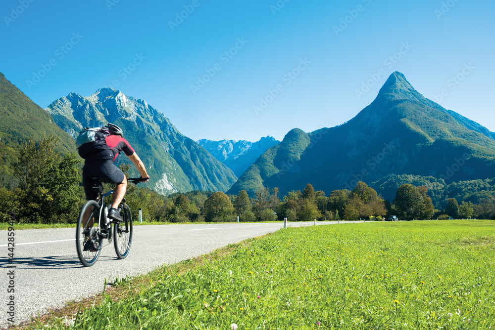 Mountain bike ride on straight road in Alps