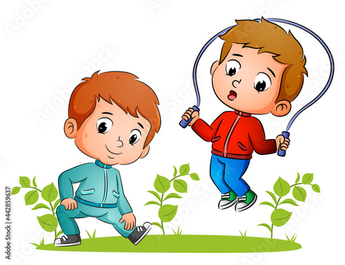 The couple of boys are doing stretching and skipping in the garden