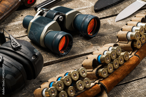 Hunting equipment binoculars on wooden background close up photo