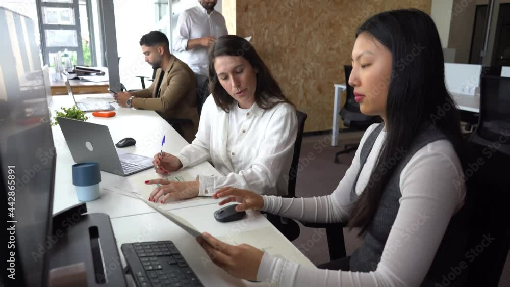 Women reading documents in office