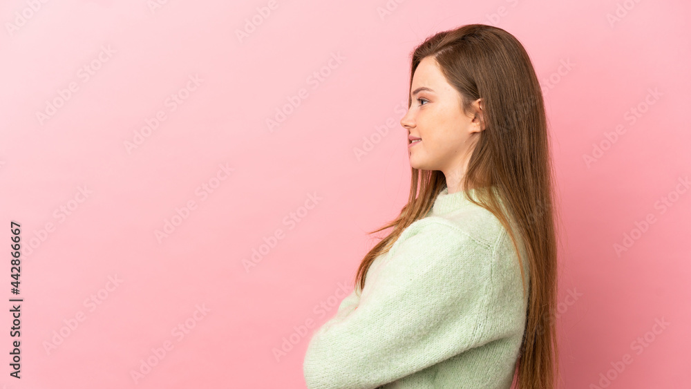 Teenager girl over isolated pink background in lateral position Teenager girl over isolated pink background in lateral position