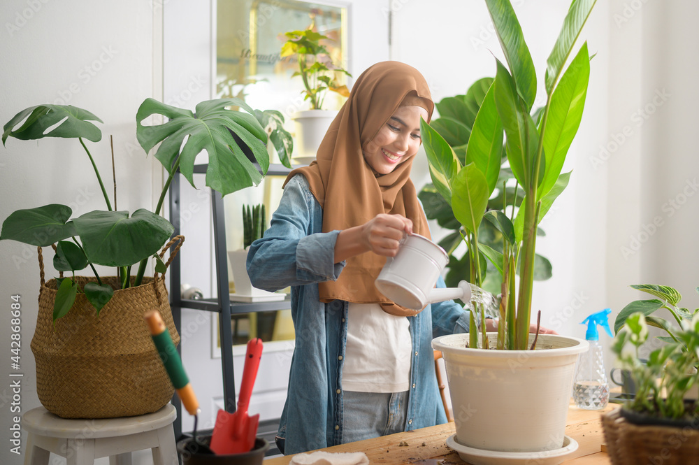 Happy young muslim woman enjoying and relaxing leisure activity in garden at home Happy young muslim woman enjoying and relaxing leisure activity in garden at home