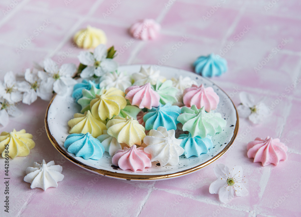 Small colorful meringues in the ceramic plate Small colorful meringues in the ceramic plate