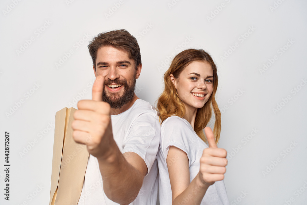 man and woman in white t-shirts package shop purchase man and woman in white t-shirts package shop purchase