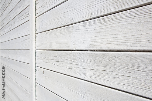Old weathered white painted wooden slatted wall