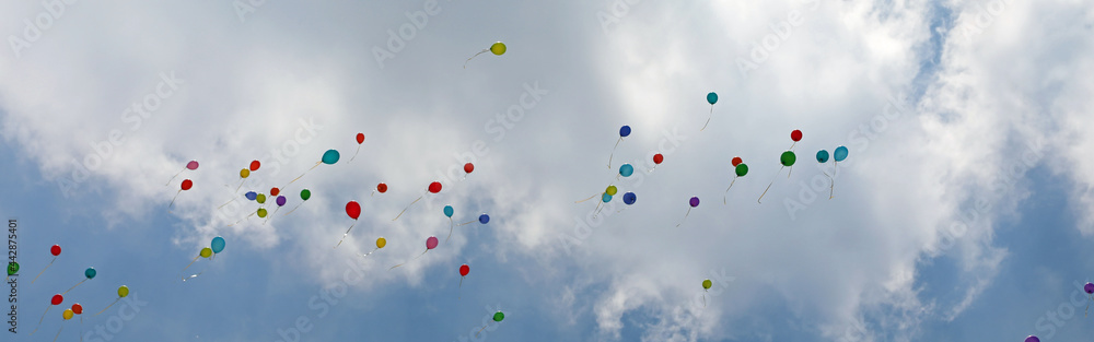 Many balloons flight in the blue sky