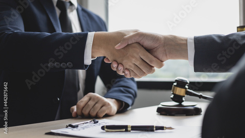 Businessman shaking hands with a lawyer or judge After signing the contract and the agreement is complete, Approval of an agreement between business and law, End of the legal case.