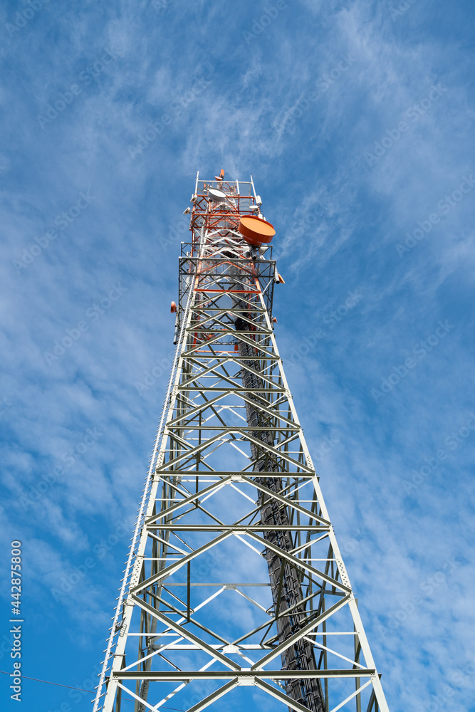 Telecommunication tower in the nice blue cloudy sky Telecommunication tower in the nice blue cloudy sky