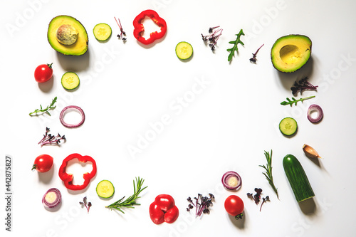 Creative layout of tomatoes, cucumbers, bell peppers, avocados and salads. flat lay. Food concept. place for your text