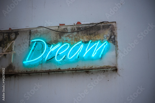 Blue neon sign Dream on a wall on London urban street