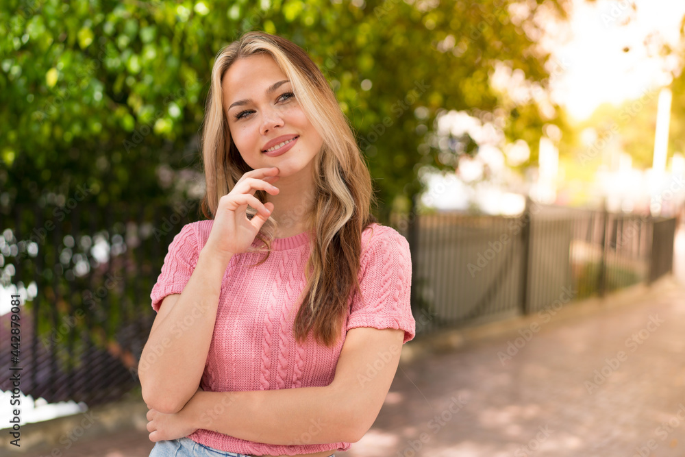 Fototapeta premium Young pretty blonde girl at outdoors . Portrait