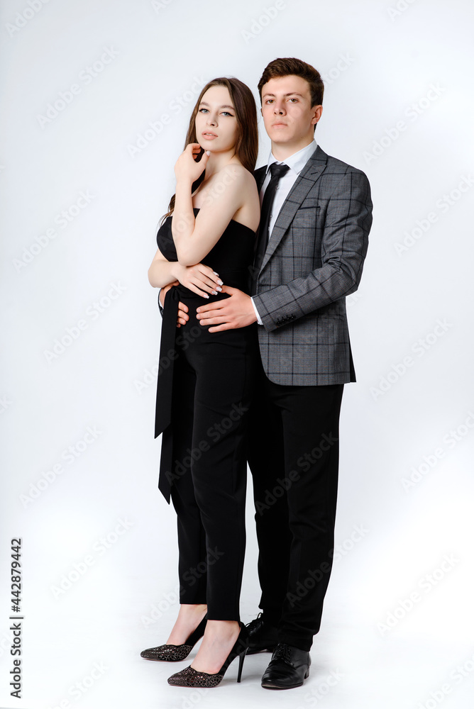 portrait of a young couple in suits on white background. portrait of a young couple in suits on white background.