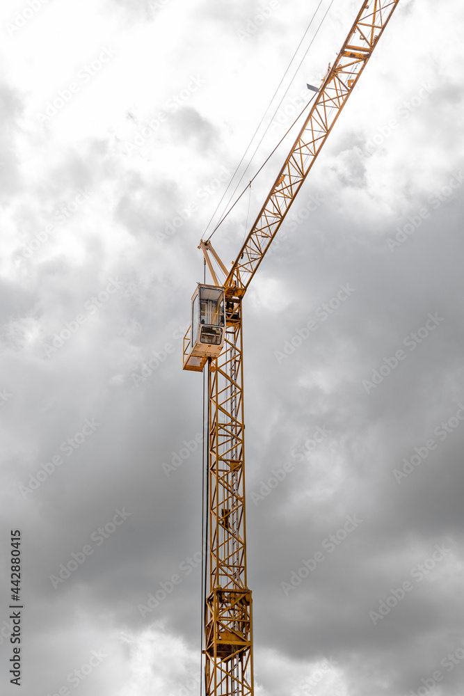 Yellow crane with gray clouds in the background Yellow crane with gray clouds in the background
