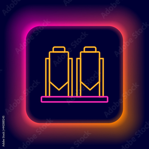 Glowing neon line Traditional brewing vessels in brewery icon isolated on black background. Beer brewing process. Distillery plant, brewery. Colorful outline concept. Vector