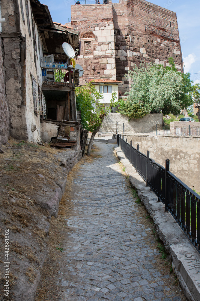 Narrow walking path around Ankara Castle and view of the castle tower