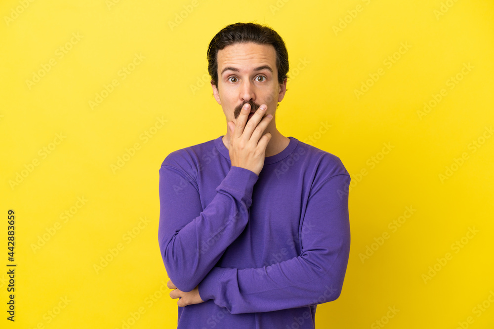 Young caucasian man isolated on yellow background surprised and shocked while looking right Young caucasian man isolated on yellow background surprised and shocked while looking right