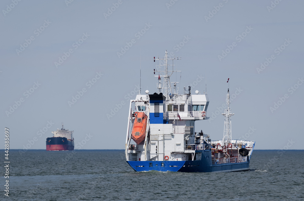 MARITIME TRANSPORT - Merchant vessels sail on waterway
