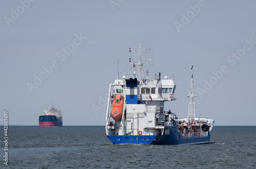 MARITIME TRANSPORT - Merchant vessels sail on waterway 