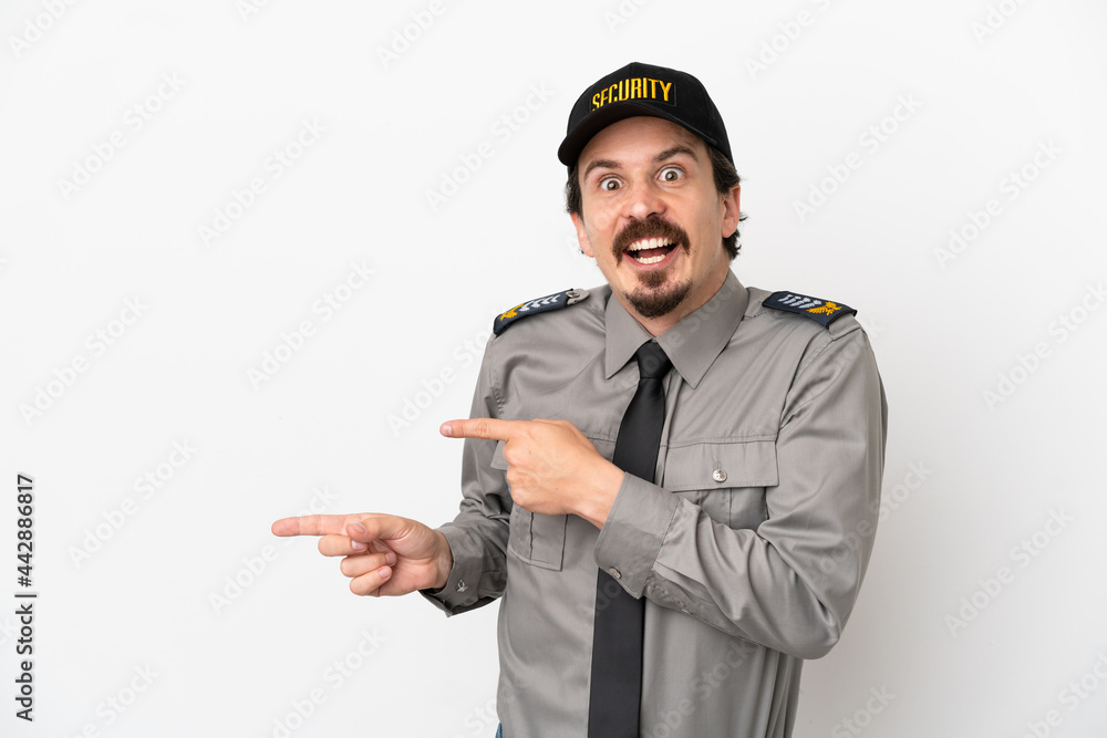 Young caucasian security man isolated on white background surprised and pointing side Young caucasian security man isolated on white background surprised and pointing side