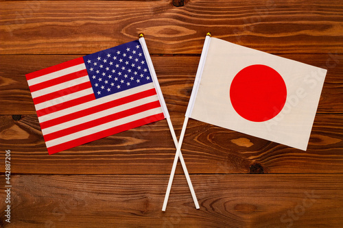 Flag of USA and flag of Japan crossed with each other. USA vs Japan. The image illustrates the relationship between countries. Photography for video news on TV and articles on the Internet and media.