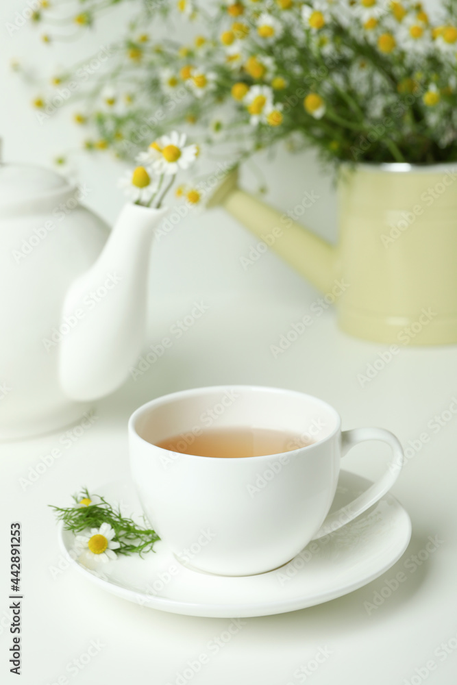 Concept of breakfast with chamomile tea on white table