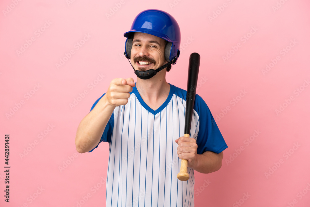 Young caucasian man playing baseball isolated on pink background pointing front with happy expression Young caucasian man playing baseball isolated on pink background pointing front with happy expression