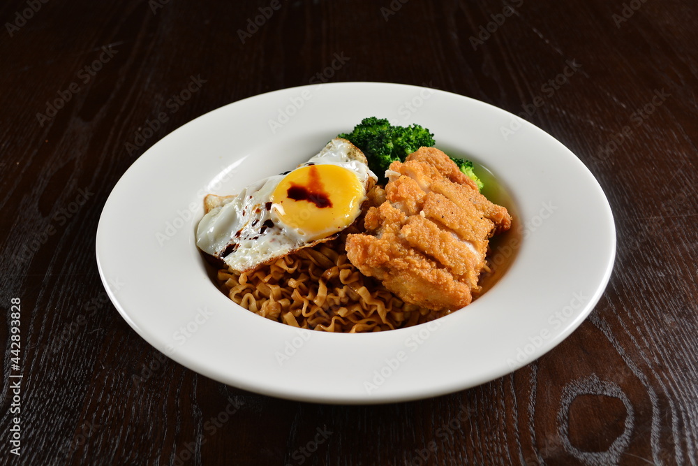 stir fried dry instant noodle mee indo in dark soya sauce with fried egg and crispy chicken chop asian halal menu stir fried dry instant noodle mee indo in dark soya sauce with fried egg and crispy chicken chop asian halal menu