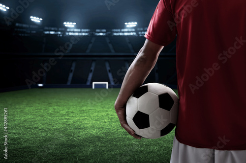 Soccer player holding a ball © fotokitas