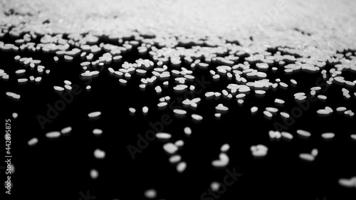 Texture of scattered rice on a black background