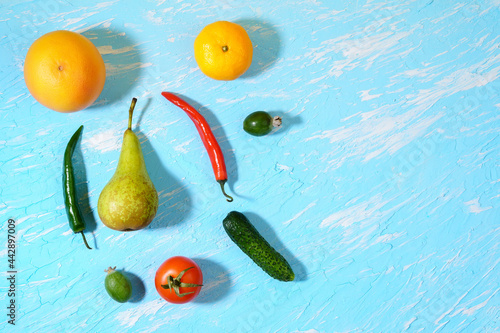 Fototapeta Naklejka Na Ścianę i Meble -  Fruits and vegetables on blue background, flat lay. Copy space