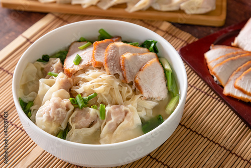 Wonton food with dumpling and roasted pork in bowl as local Chinese food