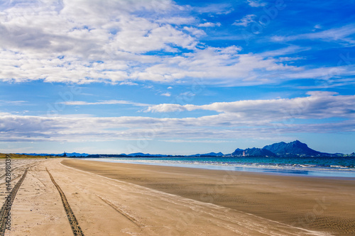 Tire tracks on an empty sandy beach