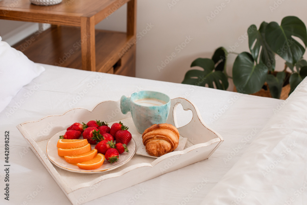Romantic atmosphere in bedroom, sweet breakfast on tray Romantic atmosphere in bedroom, sweet breakfast on tray