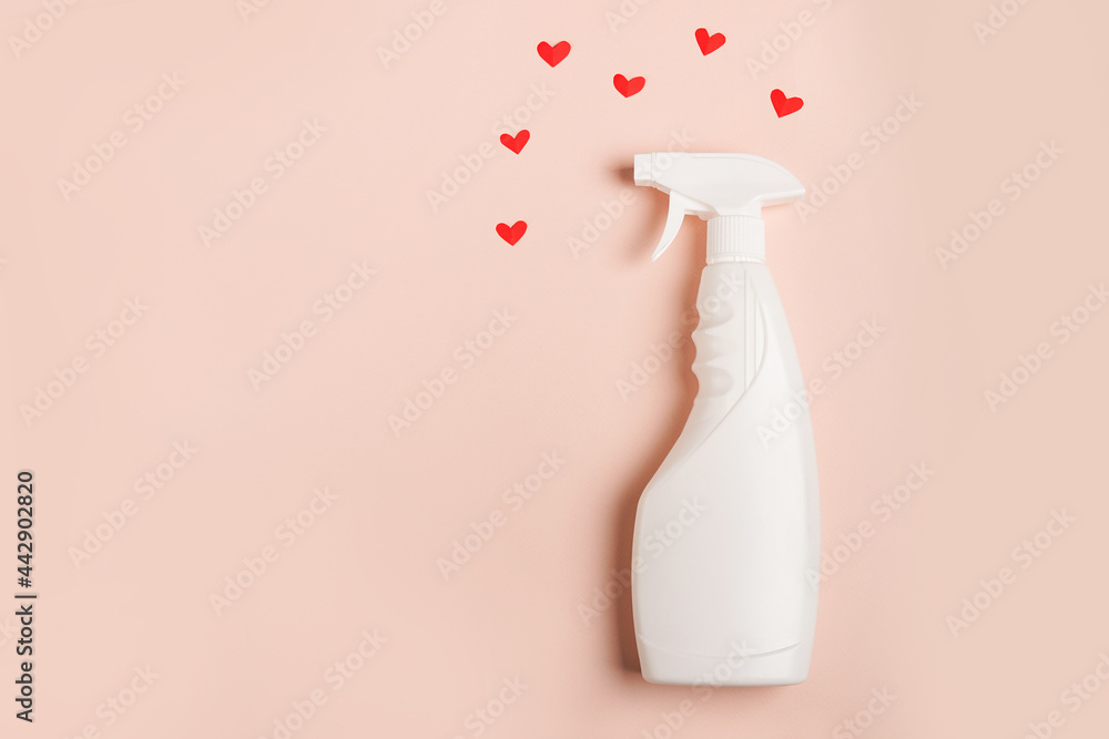 A spray of cleaning fluid on a pink background with hearts. Copy space A spray of cleaning fluid on a pink background with hearts. Copy space