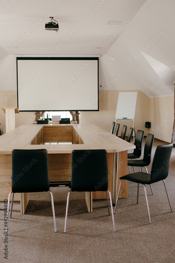 Conference table and a projector in an empty light meeting toom Conference table and a projector in an empty light meeting toom