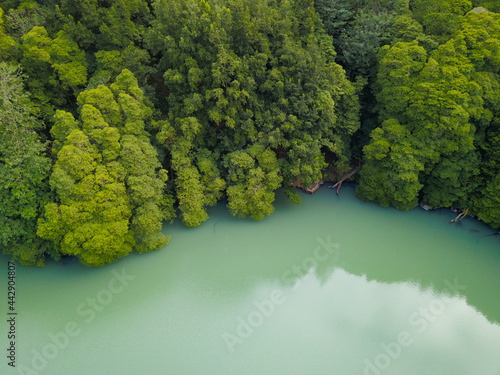 Aerial drone view of a turquoise water lake in Azores islands.
